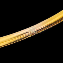 Load image into Gallery viewer, Close-up of a blemish on a yellow gold bangle
