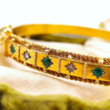 Load image into Gallery viewer, A yellow gold Etruscan style bangle bracelet set with emeralds and diamonds
