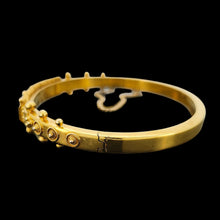 Load image into Gallery viewer, A yellow gold Etruscan style bangle bracelet set with emeralds and diamonds

