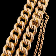 Load image into Gallery viewer, A rose gold curb link bracelet, with a safety chain, on a black background
