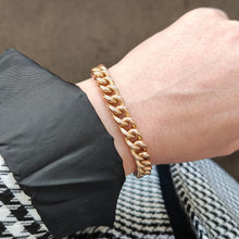Load image into Gallery viewer, A rose gold curb link bracelet, modelled on a wrist
