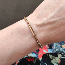 Load image into Gallery viewer, A yellow gold box link bracelet, modelled on a wrist

