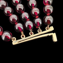Load image into Gallery viewer, A five row round garnet bead bracelet with a clasp in yellow gold
