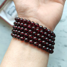 Load image into Gallery viewer, A five row round garnet bead bracelet, modelled on a wrist
