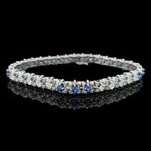 Load image into Gallery viewer, A sapphire and diamond white gold line bracelet, on a black background
