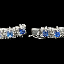 Load image into Gallery viewer, A close-up of the clasp of asapphire and diamond white gold line bracelet, on a black background
