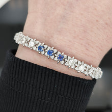 Load image into Gallery viewer, A sapphire and diamond white gold line bracelet, modelled on a wrist
