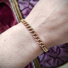 Load image into Gallery viewer, A rose gold curb link bracelet, modelled on a wrist
