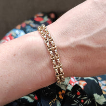 Load image into Gallery viewer, A double row oval and bead link bracelet in yellow gold, modelled on a wrist
