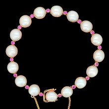 Load image into Gallery viewer, A pearl and ruby bracelet in rose gold, on a black background
