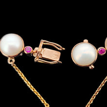 Load image into Gallery viewer, Close-up of a pearl and ruby bracelet in rose gold, with a push-in clasp, on a black background
