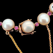 Load image into Gallery viewer, Close-up of a pearl and ruby bracelet in rose gold, with a safety chain, on a black background

