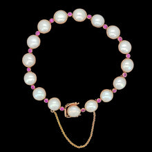 Load image into Gallery viewer, A pearl and ruby bracelet in rose gold, on a black background
