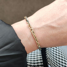 Load image into Gallery viewer, A yellow and white gold link bracelet, modelled on a wrist
