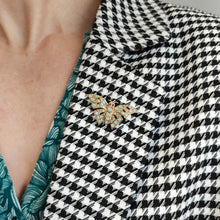 Load image into Gallery viewer, A yellow gold butterfly brooch with opals and ruby eyes, modelled on a houndstooth print jacket
