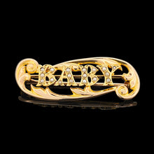Load image into Gallery viewer, A yellow gold brooch with the word BABY written in pearls, on a black background
