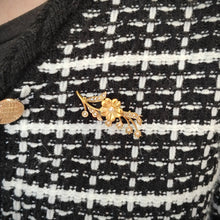 Load image into Gallery viewer, A yellow gold pearl set floral brooch, modelled on a black and white knitted jacket
