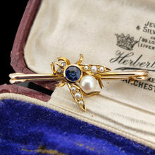 Load image into Gallery viewer, A yellow gold fly bar brooch with sapphire, pearls and diamond eyes, sitting in an antique box

