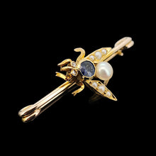 Load image into Gallery viewer, A yellow gold fly bar brooch with sapphire, pearls and diamond eyes, on a black background
