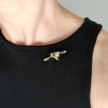 Load image into Gallery viewer, A yellow gold fly bar brooch with sapphire, pearls and diamond eyes, modelled by a woman wearing a black top
