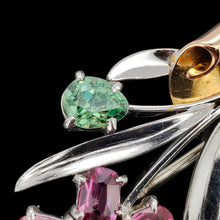 Load image into Gallery viewer, Close-up of a ruby and green zircon flower bouquet brooch in white and rose gold, on a black background
