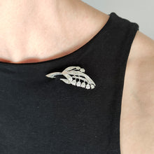 Load image into Gallery viewer, A white gold lily of the valley floral brooch set with diamonds, modelled by a woman wearing a black top
