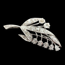 Load image into Gallery viewer, A white gold lily of the valley floral brooch set with diamonds, on a black background
