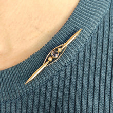 Load image into Gallery viewer, A yellow gold sapphire and pearl bar brooch, modelled on the neck of a blue top

