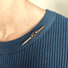 Load image into Gallery viewer, A yellow gold sapphire and pearl bar brooch, modelled on the neck of a blue top
