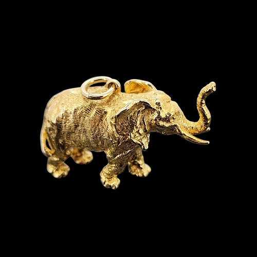 Large Vintage 9ct Yellow Gold Elephant Charm/Pendant facing right, on a black background