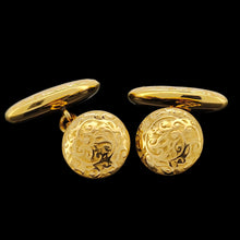 Load image into Gallery viewer, A pair of yellow gold engraved oval and round cufflinks, on a black background
