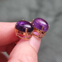 Load image into Gallery viewer, v9ct Gold Cabochon Amethyst Stud Earrings in hand
