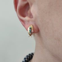 Load image into Gallery viewer, A yellow gold turquoise leaf shaped earring, modelled in an ear

