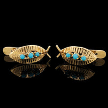 Load image into Gallery viewer, A pair of yellow gold turquoise leaf shaped earrings, on a black background
