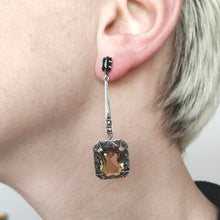 Load image into Gallery viewer, A citrine, onyx and marcasite long drop earring in silver, modelled in an ear
