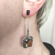 Load image into Gallery viewer, A citrine, onyx and marcasite long drop earring in silver, modelled in an ear
