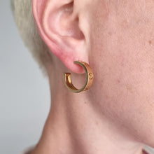 Load image into Gallery viewer, Gold Cartier hoop earring modelled in an ear
