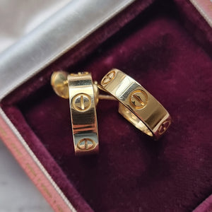 Gold Cartier hoop earrings in a jewellery box