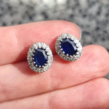 Load image into Gallery viewer, Vintage 18ct Gold Sapphire and Diamond Oval Cluster Stud Earrings in hand
