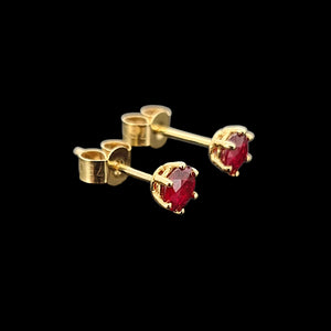 18ct Yellow Gold Ruby Solitaire Stud Earrings side view, on a black background