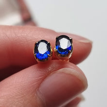 Load image into Gallery viewer, 18ct Yellow Gold Oval Sapphire Stud Earrings in hand
