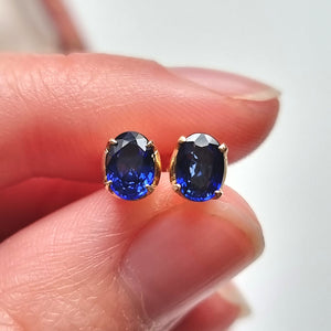 18ct Yellow Gold Oval Sapphire Stud Earrings in hand