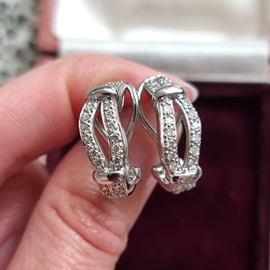 18ct White Gold Brilliant Cut Diamond Oval Hoop Earrings in hand