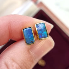 Load image into Gallery viewer, 18ct Gold Black Opal Stud Earrings in hand
