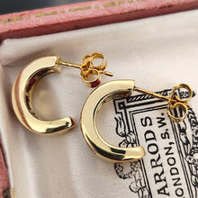 Load image into Gallery viewer, A pair of yellow gold hoop earrings channel set with square cut rubies

