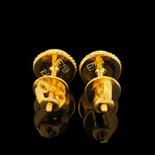 Load image into Gallery viewer, A pair of round jade stud earrings in yellow gold, on a black background
