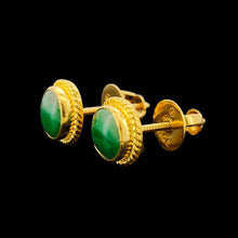 Load image into Gallery viewer, A pair of round jade stud earrings in yellow gold, on a black background
