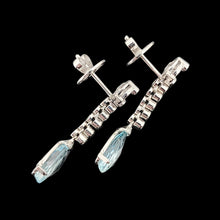 Load image into Gallery viewer, A pair of aquamarine and diamond drop earrings in white gold, on a black background
