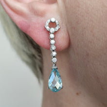 Load image into Gallery viewer, An aquamarine and diamond drop earring in white gold, modelled in an ear
