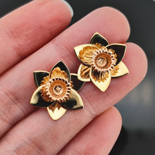 Load image into Gallery viewer, A pair of yellow gold daffodil flower stud earrings, held in a hand
